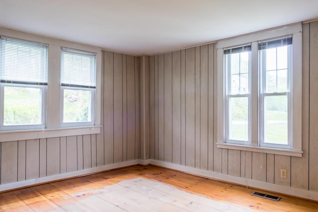 57 Bow St, Freeport, ME 04032 - spare room with light wood-style flooring, healthy amount of natural light, and wood walls