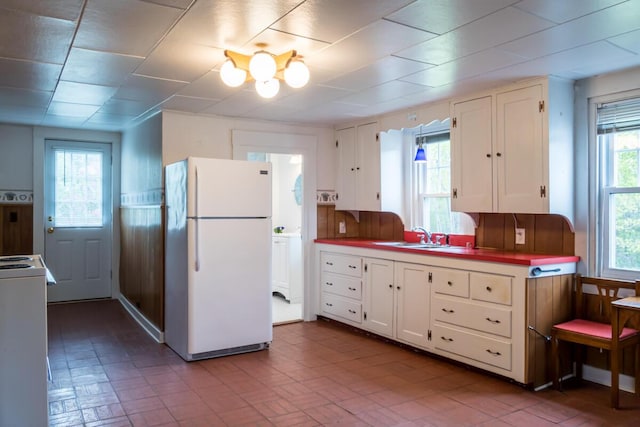 57 Bow St, Freeport, ME 04032 - kitchen featuring freestanding refrigerator, a sink, white cabinets, and stove