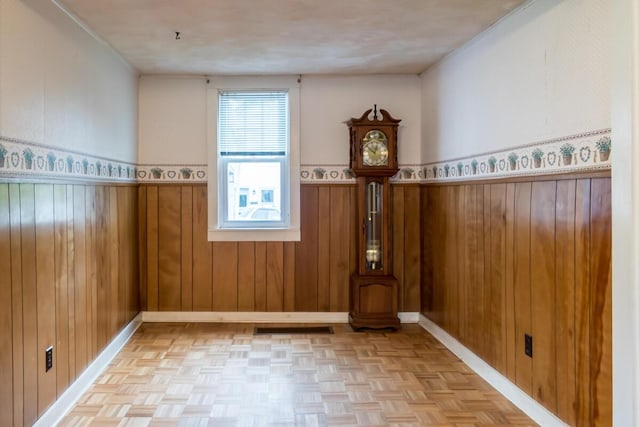 57 Bow St, Freeport, ME 04032 - unfurnished room with a wainscoted wall, baseboards, and wooden walls
