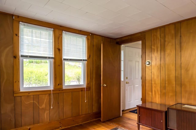 57 Bow St, Freeport, ME 04032 - empty room with wood walls and hardwood / wood-style flooring