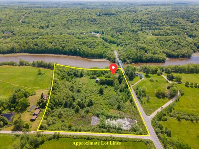 79 Patterson Rd, Dresden, ME 04342 - aerial view of property's location featuring property boundaries highlighted, a heavily wooded area, and a large body of water