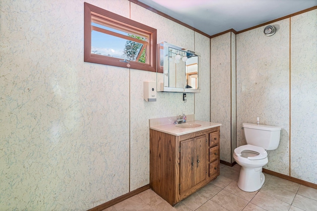 27 Maple St, Limerick, ME 04048 - bathroom featuring ornamental molding, vanity, toilet, tile patterned floors, and baseboards