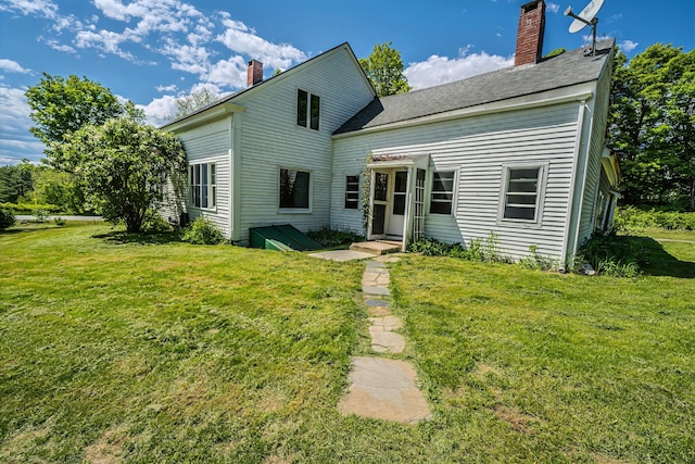 176 Bagley Hill Rd, Troy, ME 04987 - view of front facade featuring a chimney, a front yard, and a shingled roof