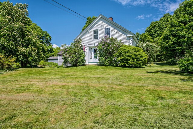 176 Bagley Hill Rd, Troy, ME 04987 - view of front facade featuring a chimney and a front lawn