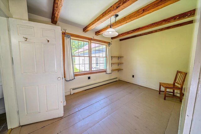 176 Bagley Hill Rd, Troy, ME 04987 - unfurnished room featuring a baseboard heating unit, beamed ceiling, and light wood-style flooring