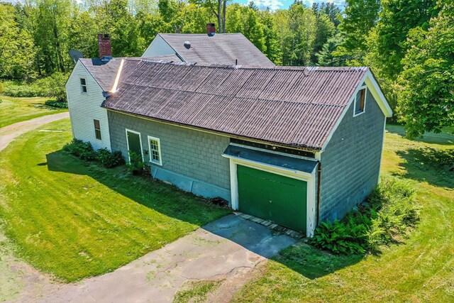176 Bagley Hill Rd, Troy, ME 04987 - view of front of house with a front yard, a chimney, concrete driveway, roof with shingles, and a garage