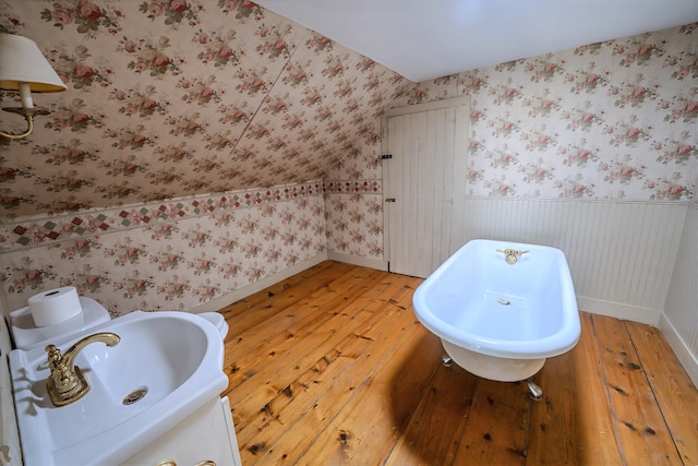 176 Bagley Hill Rd, Troy, ME 04987 - bathroom featuring wood-type flooring, a sink, wainscoting, wallpapered walls, and baseboards