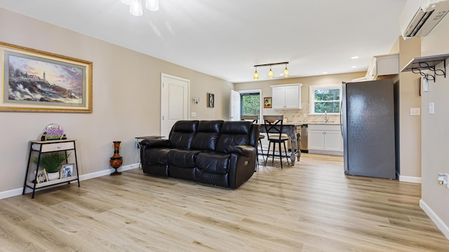 51 Stearns Farm Rd, Hampden, ME 04444 - living area with a wall unit AC, light wood-style floors, baseboards, and recessed lighting