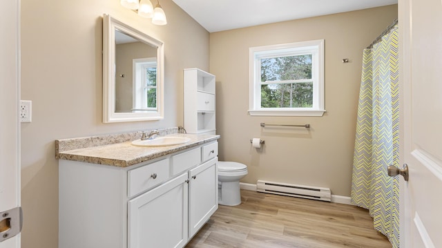 51 Stearns Farm Rd, Hampden, ME 04444 - bathroom with baseboard heating, vanity, toilet, wood finished floors, and baseboards