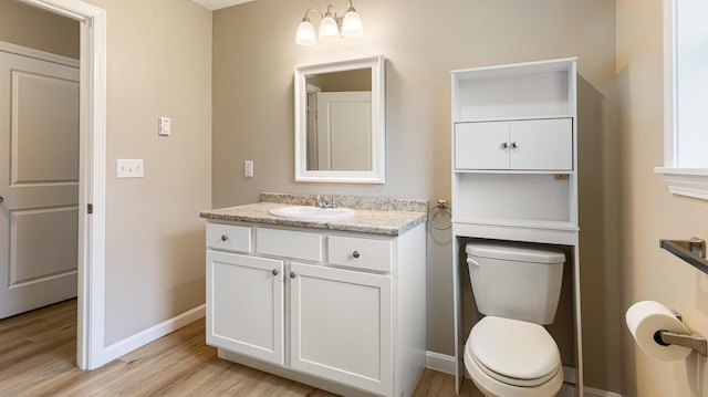 51 Stearns Farm Rd, Hampden, ME 04444 - bathroom featuring vanity, baseboards, wood finished floors, and toilet