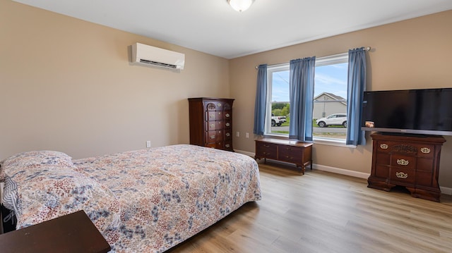 51 Stearns Farm Rd, Hampden, ME 04444 - bedroom featuring a wall unit AC, wood finished floors, and baseboards