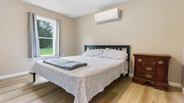 51 Stearns Farm Rd, Hampden, ME 04444 - bedroom with an AC wall unit, wood finished floors, and baseboards