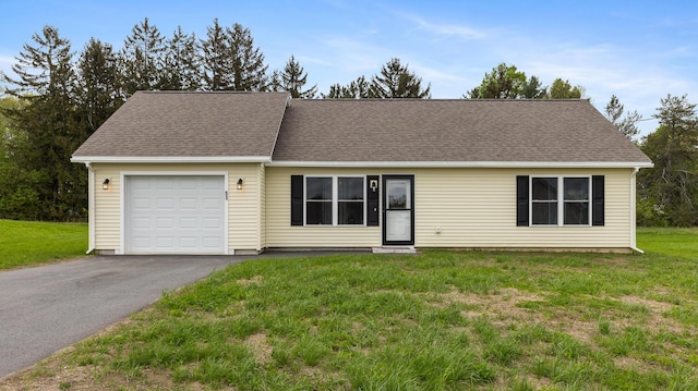 51 Stearns Farm Rd, Hampden, ME 04444 - single story home featuring a garage, asphalt driveway, a front lawn, and roof with shingles
