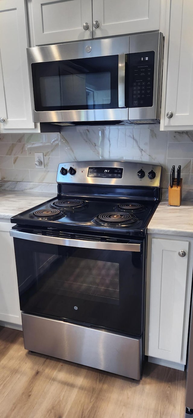 51 Stearns Farm Rd, Hampden, ME 04444 - kitchen featuring stainless steel appliances, light countertops, white cabinetry, and tasteful backsplash