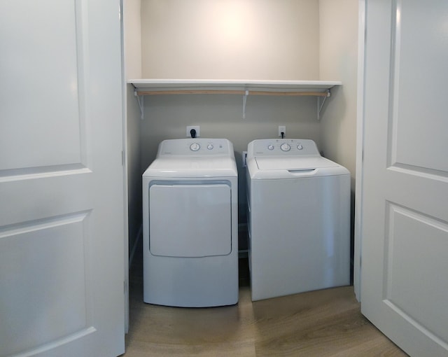 51 Stearns Farm Rd, Hampden, ME 04444 - laundry room with light wood-style flooring and separate washer and dryer