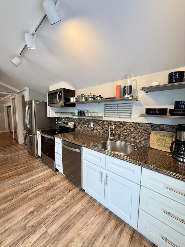 40 Shorebreezes Ln Unit 40, Kennebunk, ME 04043 - kitchen featuring open shelves, appliances with stainless steel finishes, a sink, light wood-style floors, and dark stone countertops