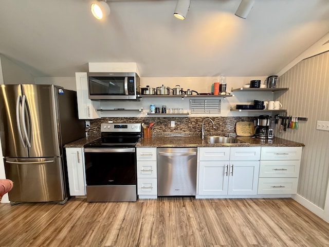 40 Shorebreezes Ln Unit 40, Kennebunk, ME 04043 - kitchen with stainless steel appliances, open shelves, a sink, light wood-style flooring, and dark stone counters
