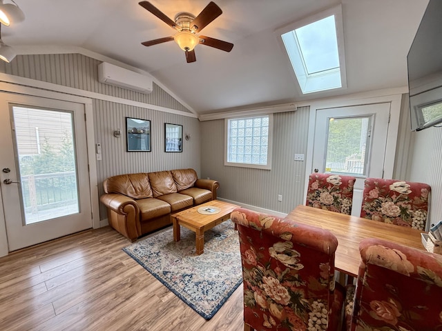 40 Shorebreezes Ln Unit 40, Kennebunk, ME 04043 - living area featuring a wall mounted air conditioner, lofted ceiling, a skylight, light wood finished floors, and a ceiling fan