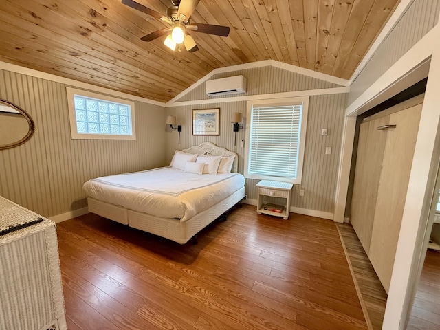 40 Shorebreezes Ln Unit 40, Kennebunk, ME 04043 - bedroom featuring a wall unit AC, lofted ceiling, wood finished floors, wooden ceiling, and baseboards