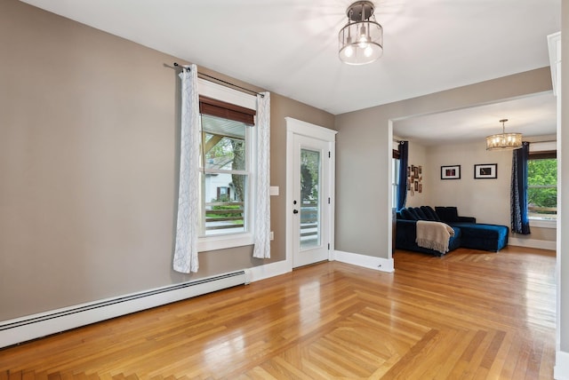 124 Dumont Ave, Lewiston, ME 04240 - entrance foyer featuring a chandelier, a baseboard heating unit, healthy amount of natural light, and baseboards