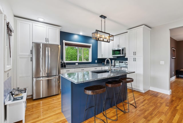 124 Dumont Ave, Lewiston, ME 04240 - kitchen featuring appliances with stainless steel finishes, a sink, dark stone counters, white cabinets, and recessed lighting