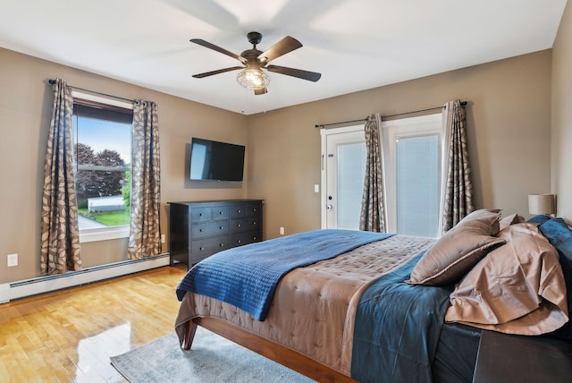 124 Dumont Ave, Lewiston, ME 04240 - bedroom featuring baseboard heating, wood finished floors, and a ceiling fan