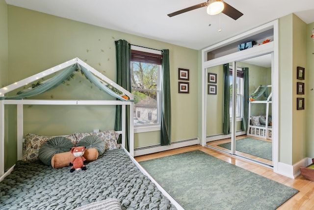 124 Dumont Ave, Lewiston, ME 04240 - bedroom with wood finished floors, baseboard heating, and a ceiling fan