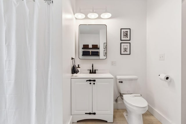 124 Dumont Ave, Lewiston, ME 04240 - full bath featuring toilet, vanity, baseboards, and curtained shower