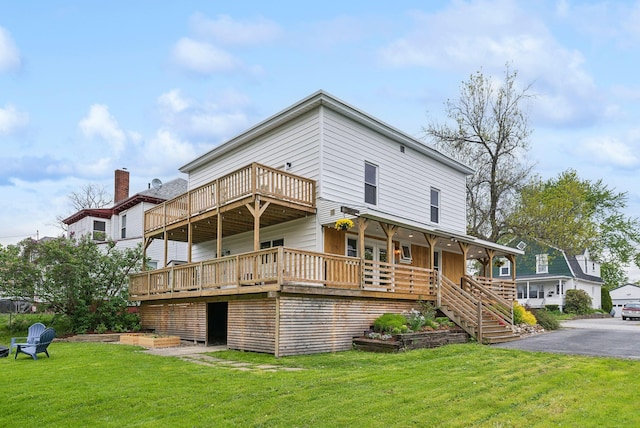 124 Dumont Ave, Lewiston, ME 04240 - back of property with a lawn, stairway, and a wooden deck