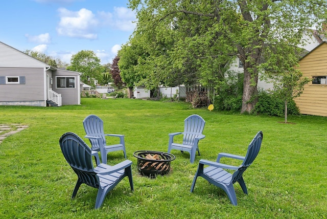 124 Dumont Ave, Lewiston, ME 04240 - view of grassy yard with a fire pit and entry steps