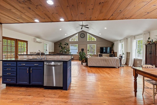39 Lobo Ln, West Gardiner, ME 04345 - kitchen with stainless steel dishwasher, a sink, blue cabinets, dark countertops, and open floor plan
