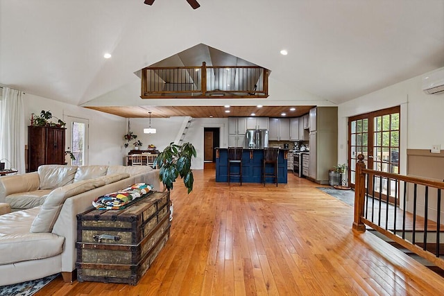 39 Lobo Ln, West Gardiner, ME 04345 - living area with a ceiling fan, light wood-type flooring, high vaulted ceiling, and an AC wall unit