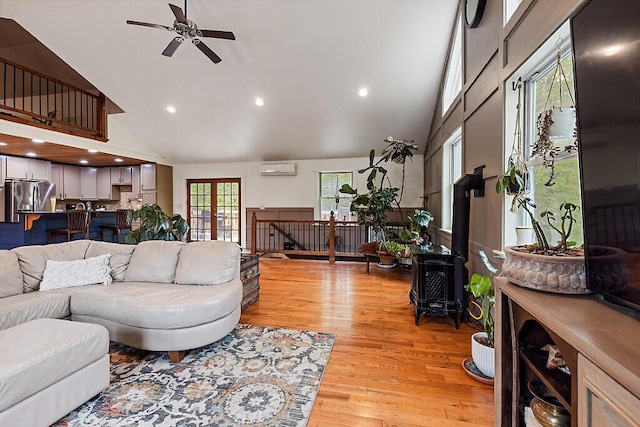 39 Lobo Ln, West Gardiner, ME 04345 - living area with high vaulted ceiling, a ceiling fan, a wall mounted air conditioner, light wood-type flooring, and recessed lighting
