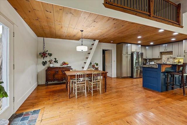 39 Lobo Ln, West Gardiner, ME 04345 - kitchen featuring stainless steel fridge, a kitchen bar, light wood-type flooring, recessed lighting, and decorative backsplash