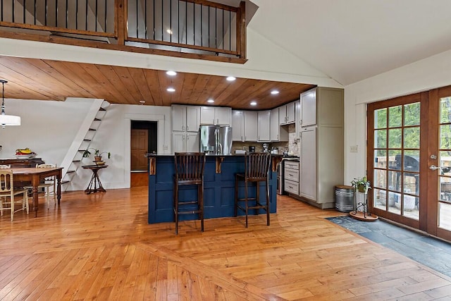 39 Lobo Ln, West Gardiner, ME 04345 - kitchen with stainless steel fridge, dark countertops, a kitchen breakfast bar, recessed lighting, and a kitchen island