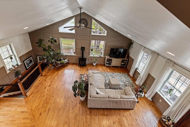 39 Lobo Ln, West Gardiner, ME 04345 - living room featuring a decorative wall, ceiling fan, a wood stove, hardwood / wood-style floors, and wainscoting