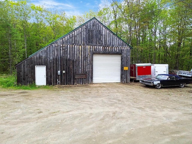 39 Lobo Ln, West Gardiner, ME 04345 - detached garage featuring driveway and a view of trees