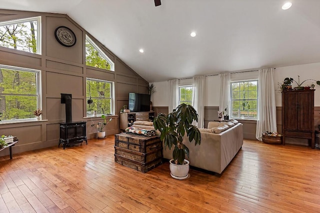 39 Lobo Ln, West Gardiner, ME 04345 - living room with a decorative wall, a wood stove, light wood-type flooring, high vaulted ceiling, and a ceiling fan