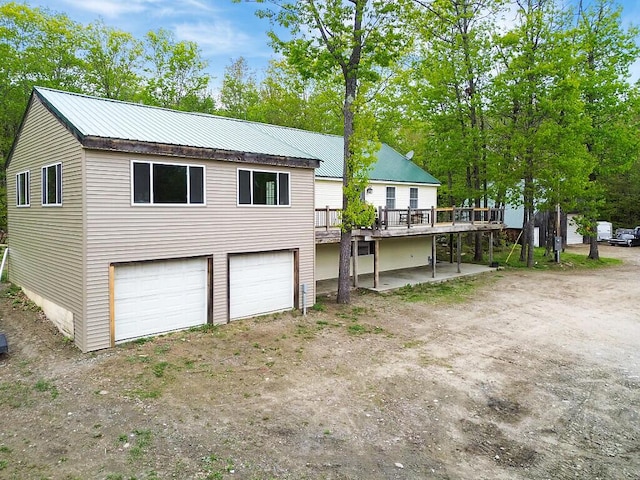 39 Lobo Ln, West Gardiner, ME 04345 - view of front of home featuring a deck, metal roof, and a garage