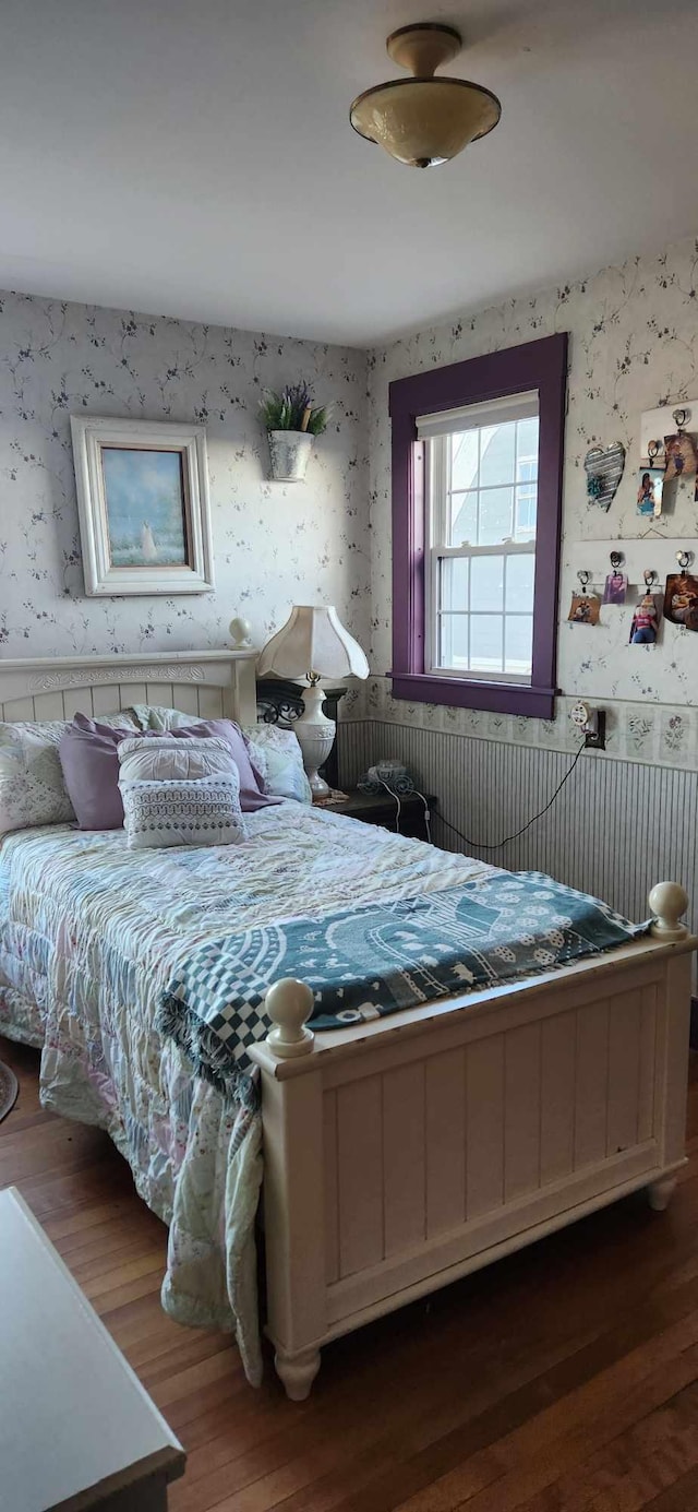 110 Bog Rd, Limestone, ME 04750 - bedroom with wallpapered walls, wood finished floors, and a wainscoted wall