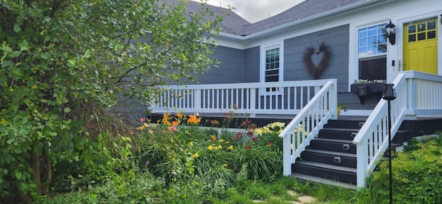 110 Bog Rd, Limestone, ME 04750 - view of exterior entry with a shingled roof and a deck