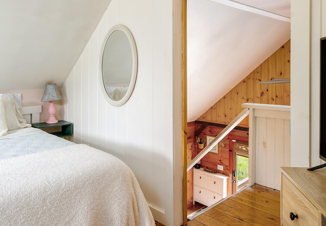 313 Sam Allen Rd, Sanford, ME 04073 - bedroom with wood walls, wood-type flooring, and vaulted ceiling