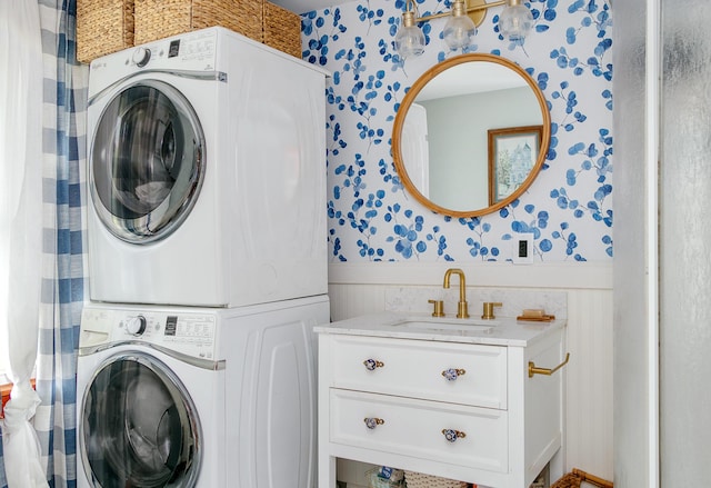 313 Sam Allen Rd, Sanford, ME 04073 - laundry area featuring stacked washer / drying machine, wallpapered walls, and wainscoting