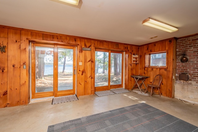 54 Papoose Island Rd, Raymond, ME 04071 - doorway to outside featuring wooden walls, concrete flooring, and crown molding