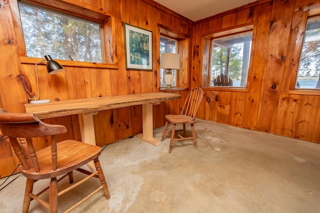 54 Papoose Island Rd, Raymond, ME 04071 - dining area with healthy amount of natural light, wood walls, and unfinished concrete flooring