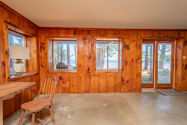 54 Papoose Island Rd, Raymond, ME 04071 - unfurnished dining area featuring wood walls, healthy amount of natural light, and concrete floors