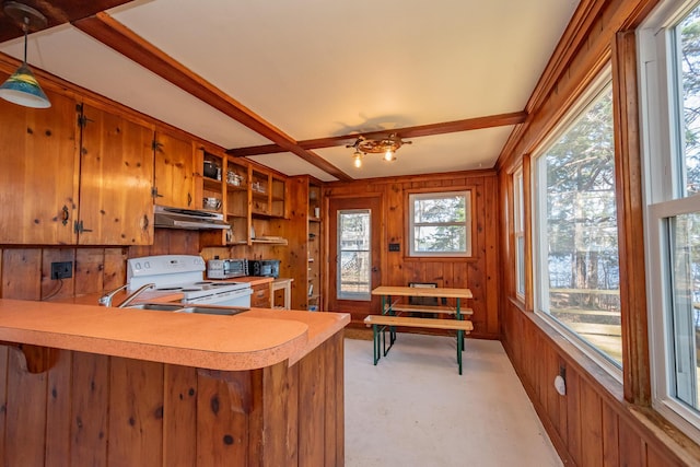 54 Papoose Island Rd, Raymond, ME 04071 - kitchen with under cabinet range hood, electric range, light countertops, brown cabinets, and open shelves