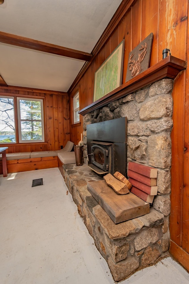 54 Papoose Island Rd, Raymond, ME 04071 - living area featuring wood walls, a wood stove, and concrete floors