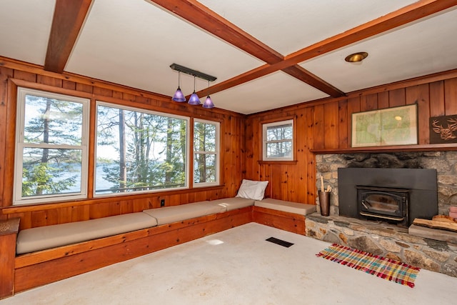 54 Papoose Island Rd, Raymond, ME 04071 - unfurnished living room featuring beamed ceiling, carpet flooring, wood walls, and a wood stove