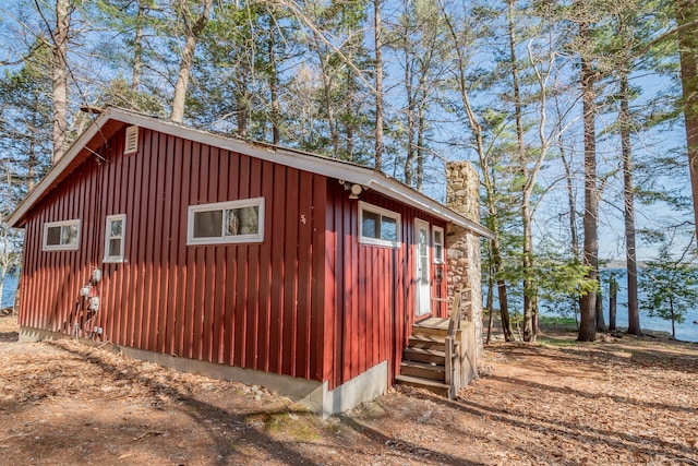 54 Papoose Island Rd, Raymond, ME 04071 - view of side of home featuring a chimney, entry steps, and board and batten siding